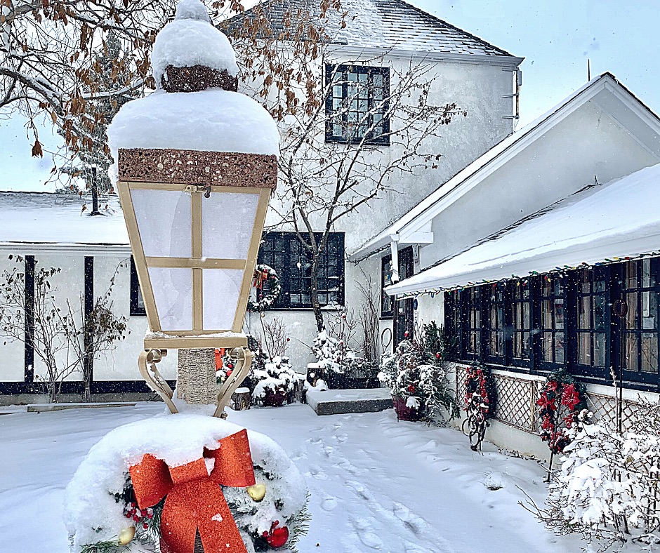 the entrance to Leighton Art Centre is shown, snow-covered and decorated with Christmas wreaths and lamps